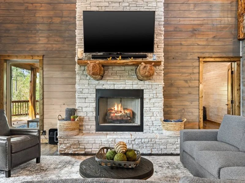 Cozy up by the stone fireplace and let the warmth of the flames embrace you in our modern rustic cabin retreat