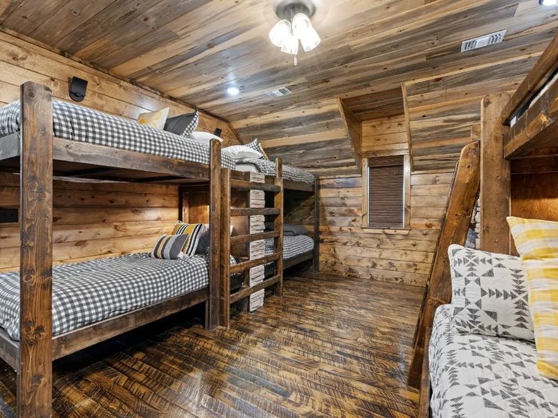 Sleepover central! Our bunkroom sleeps 10 with cozy full and twin beds, plus a spacious ensuite bathroom featuring a stone-tile shower with a relaxing rain head and triple sinks for added convenience
