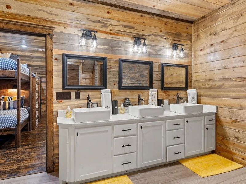 Effortless mornings start here! The triple sink ensuite off the bunkroom offers ample space and convenience for all, ensuring a smooth start to your day's activities