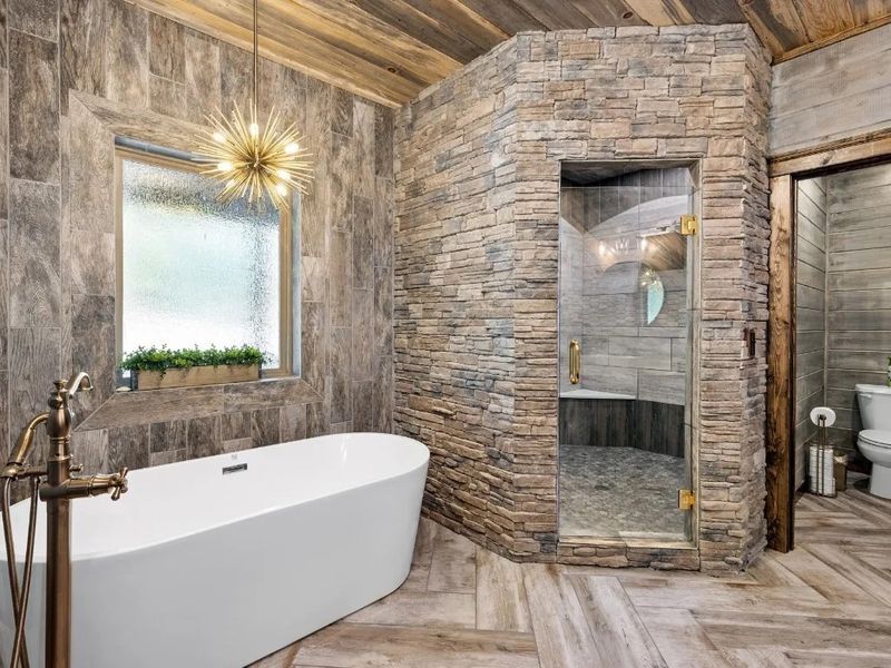 Step into luxury in our ensuite bathroom, featuring a stand-alone tub and rain head shower for a spa-like experience that rejuvenates the senses