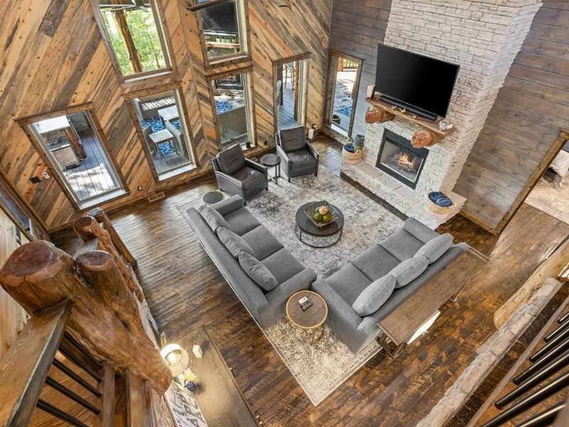 Savor the serenity of our cabin living room, where the forest provides the perfect backdrop for gatherings and relaxation