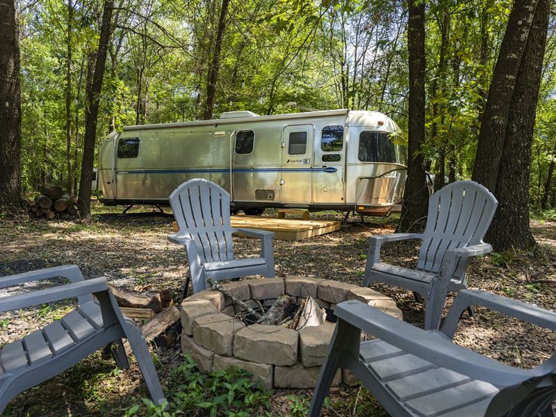 Each of our 6 remodeled Airstreams has its own patio and fire pit! Inquire to add any of the Airstreams to your stay!