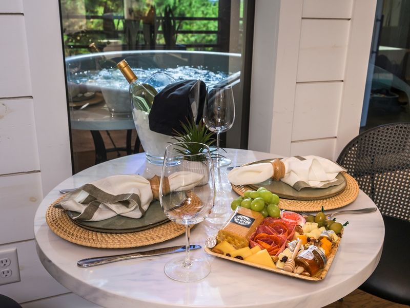 Toast to slow moments — share a bottle of wine, a charcuterie board, and laughter before slipping into the hot tub under the trees.