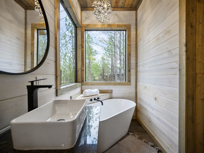 Retreat to this serene sanctuary with wooden walls and a stylish bathtub - ultimate relaxation awaits!