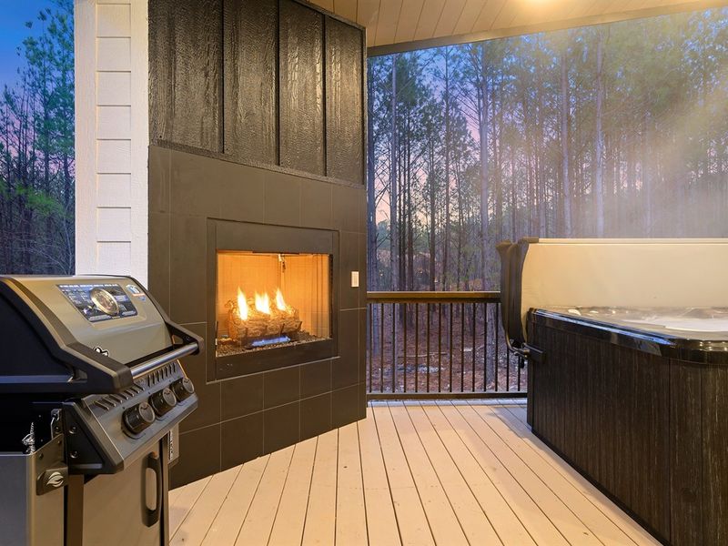Unwind fireside on the screened porch, where forest views meet modern comfort.