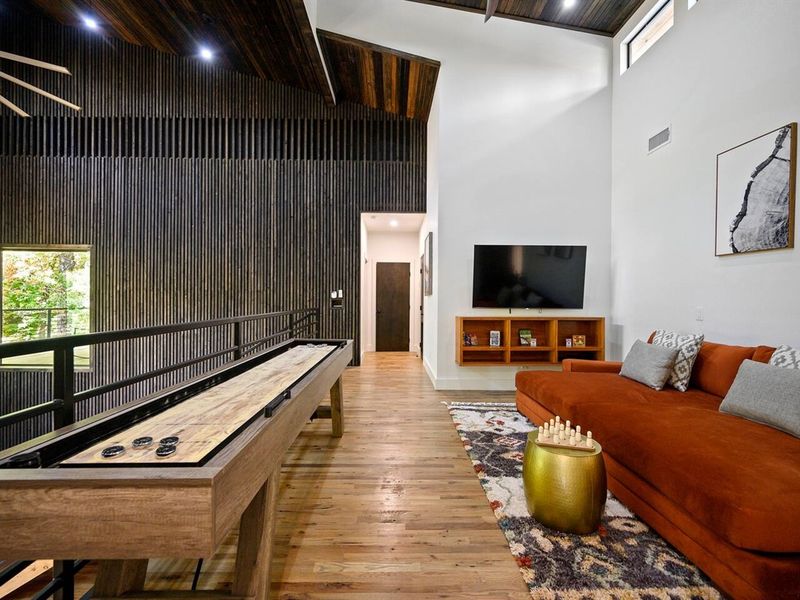 Upstairs game room loft with shuffleboard table (sleeps 5)