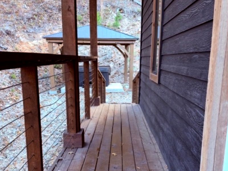 Your private escape continues outdoors — stroll to the hot tub tucked beneath the trees