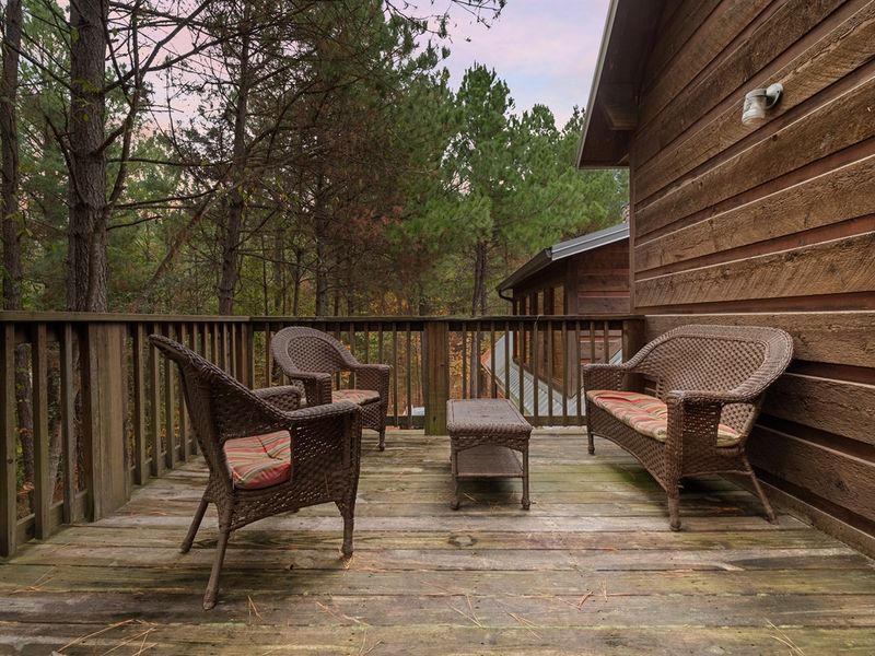 Step out of the primary suite and onto the private patio, where you can relax amidst towering trees and enjoy a view of the cozy firepit—an ideal spot for peaceful moments under the stars.