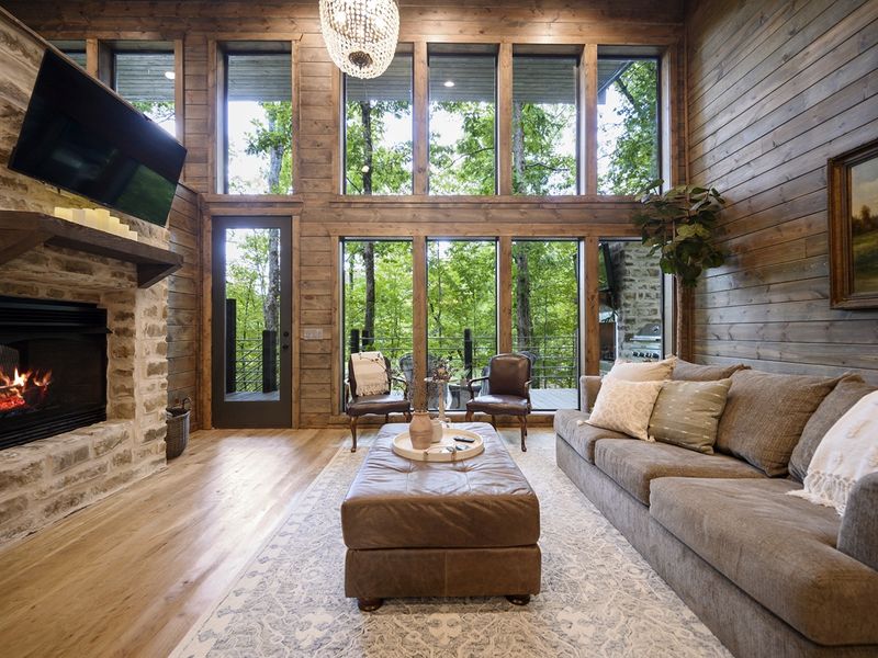 Cozy up in our inviting living room, where comfort meets stunning views. Whether it's game night or movie time, our cabin is perfect for all ages.
