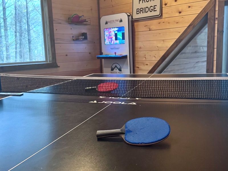 Double the fun — this game-room table converts from a full-size pool table to a table tennis setup at our Broken Bow cabin