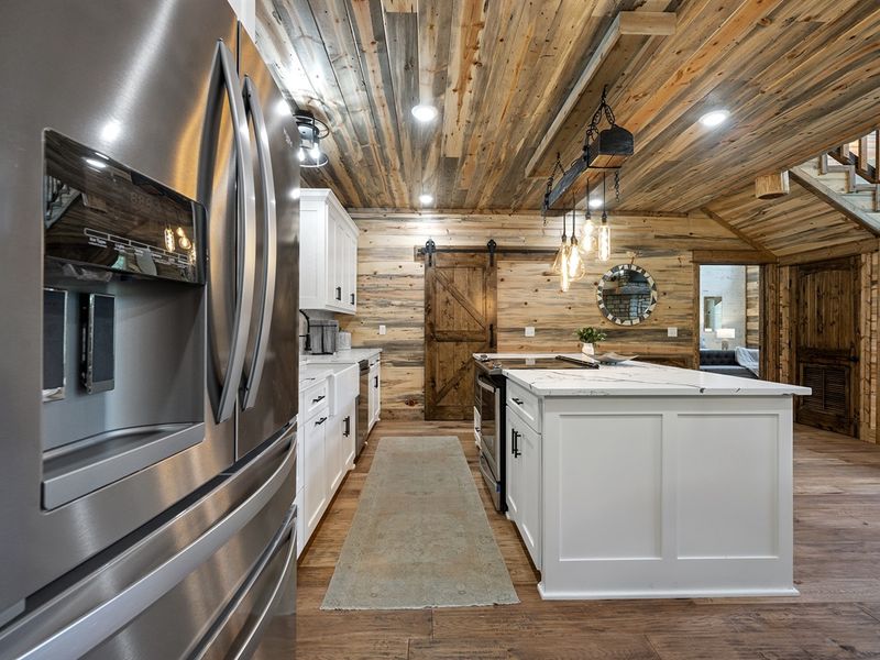 "Culinary dreams come to life in our spacious kitchen — the heartbeat of our cabin."