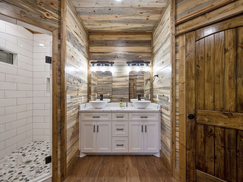"Unwind in elegance with a freestanding bath and serene stone-bottom shower."