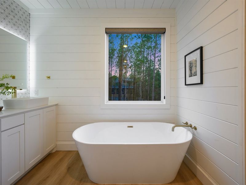 Relax and recharge in the spa-inspired master bath featuring a sleek freestanding soaking tub.
