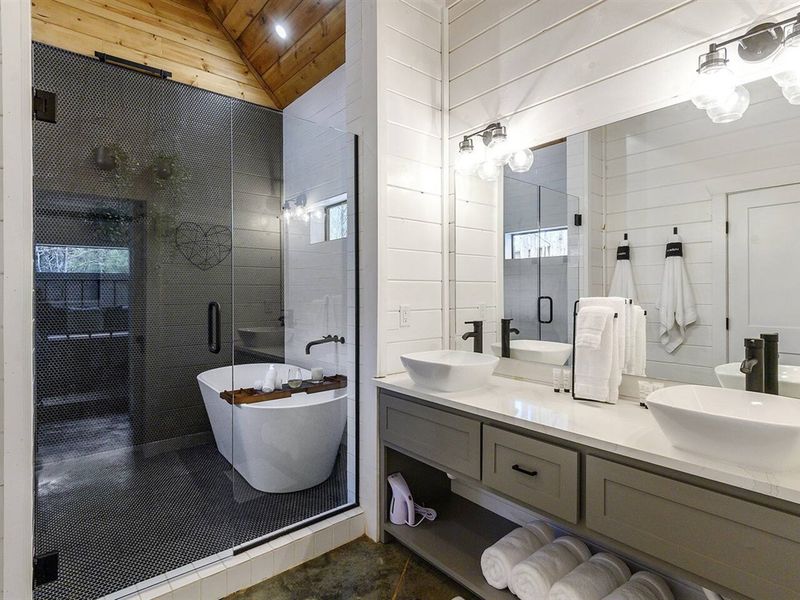 Unwind in style in our spa-like bathroom, featuring a spacious double shower and soaking bathtub. Pamper yourself after a day of adventures.