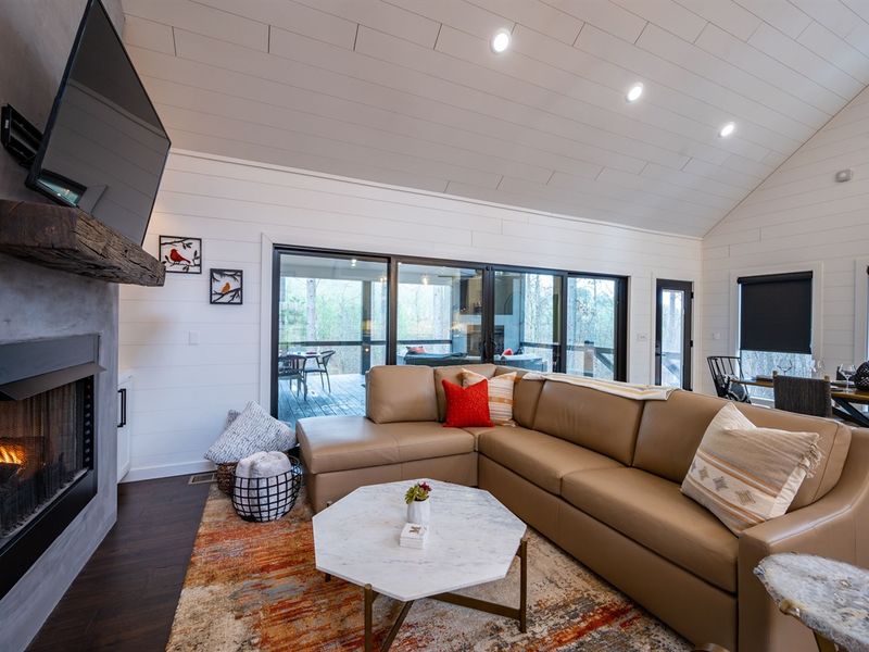 Cascading glass doors open onto the spacious back deck