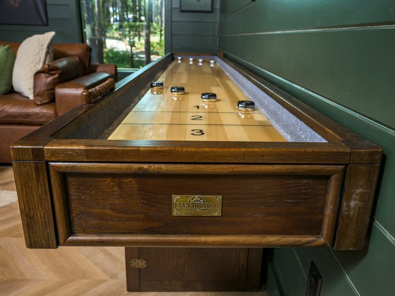 Challenge your family and friends to a game of shuffleboard on this gorgeous full-size table.