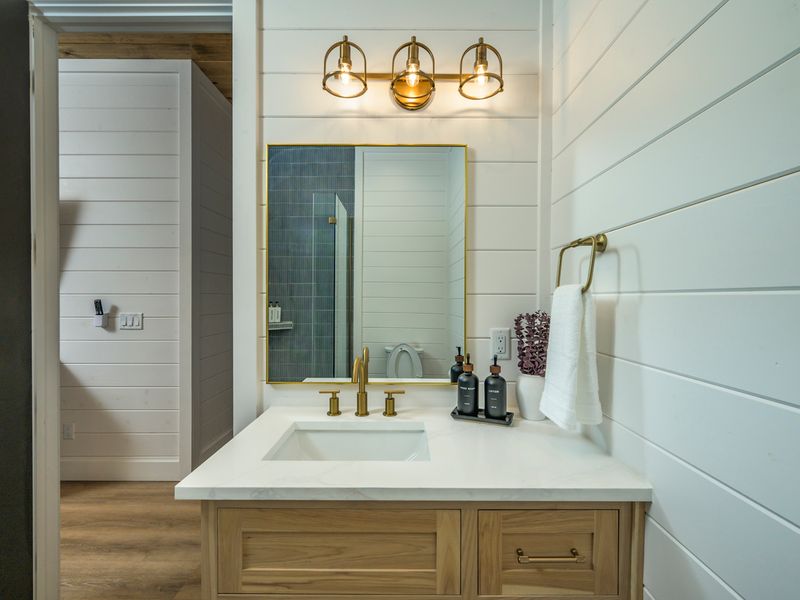 From the custom tilework to the brushed-gold fixtures, every detail of this bathroom was thoughtfully designed for comfort and style.