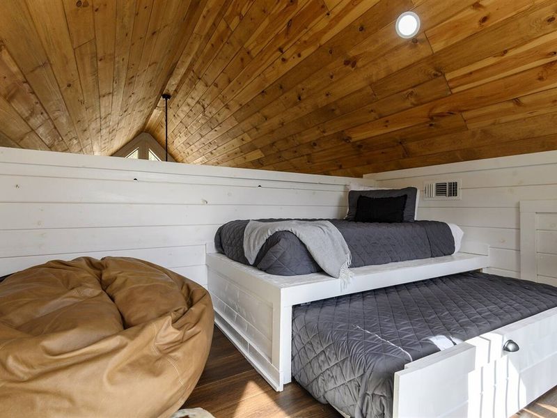 Relax and recharge in the cozy beanbag chair and soft accent rug of our inviting loft space. It's the perfect hideaway for some well-deserved downtime.