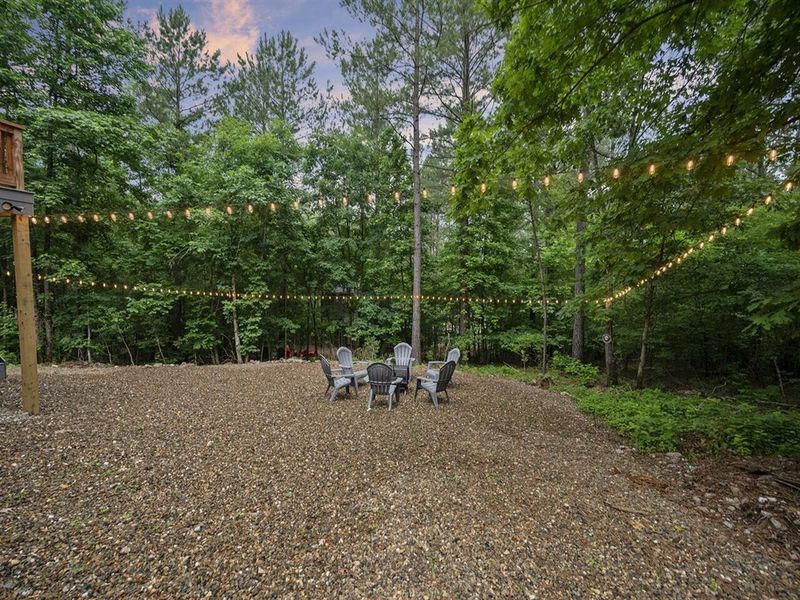 String lights surrounding outdoor fire pit