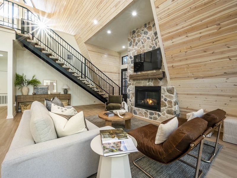 Modern meets rustic with a sleek metal staircase and warm cabin details