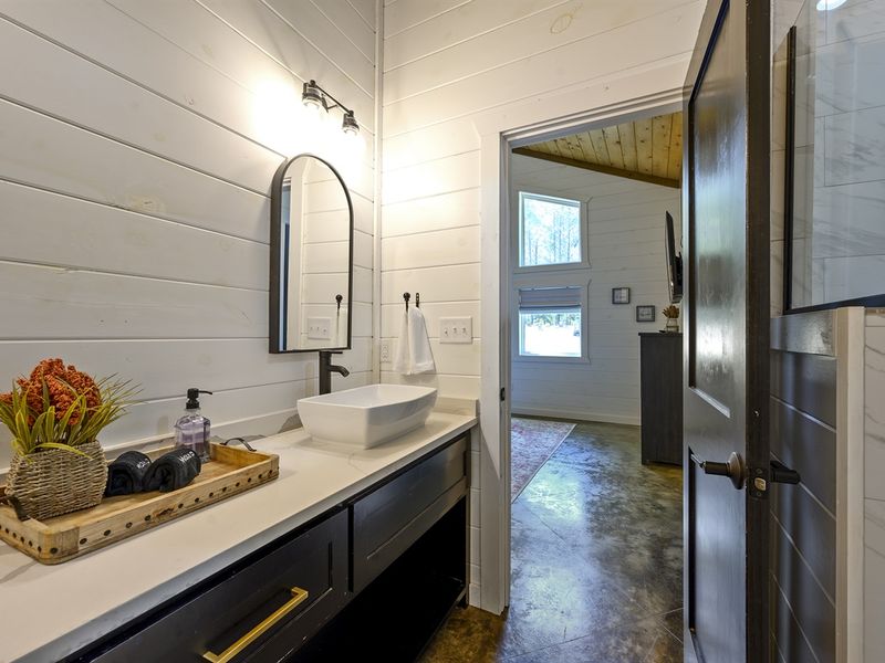 "Relax in the tile shower and double sinks of the primary bathroom."