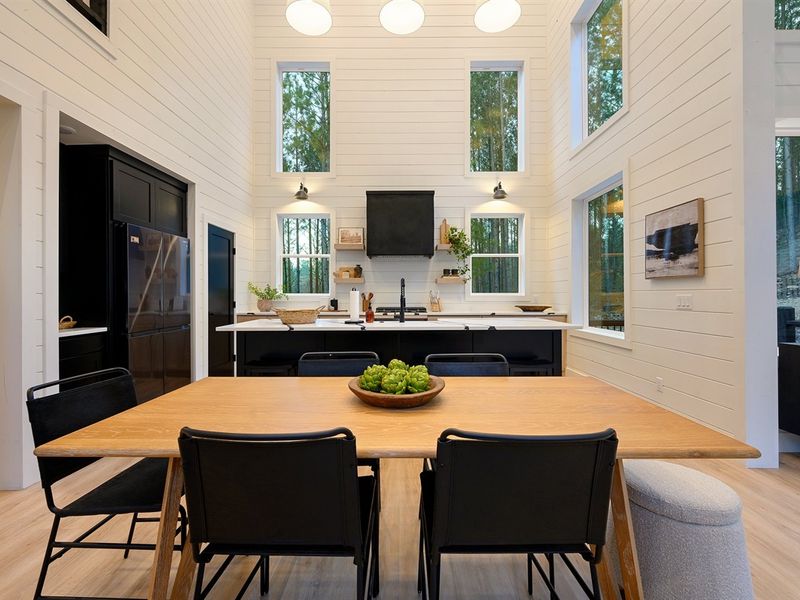 The dining table sits just steps from the kitchen, perfect for shared meals and late-night conversations.