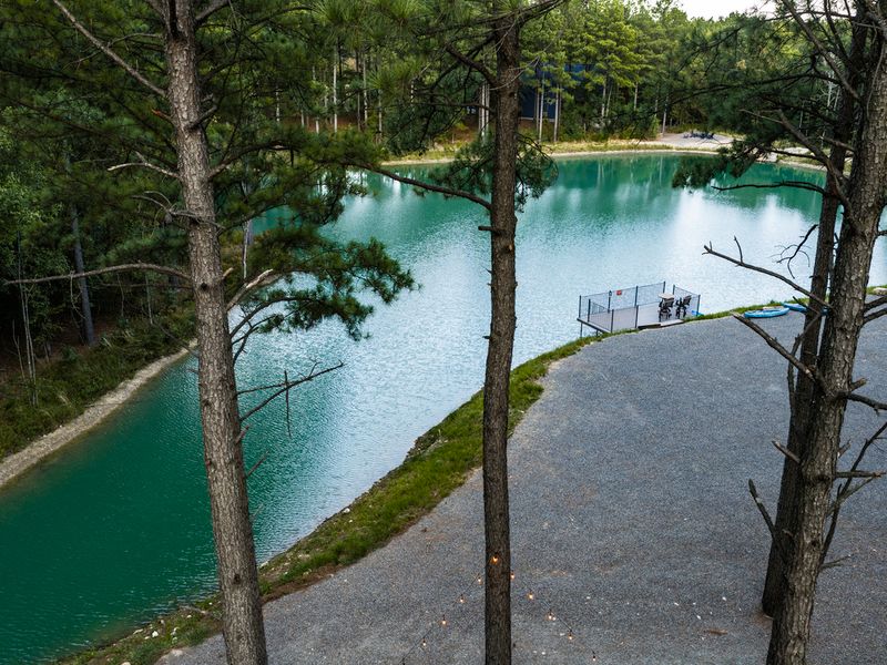The private fishing pond winds through the property, adding a tranquil natural element and endless opportunities to enjoy the outdoors.