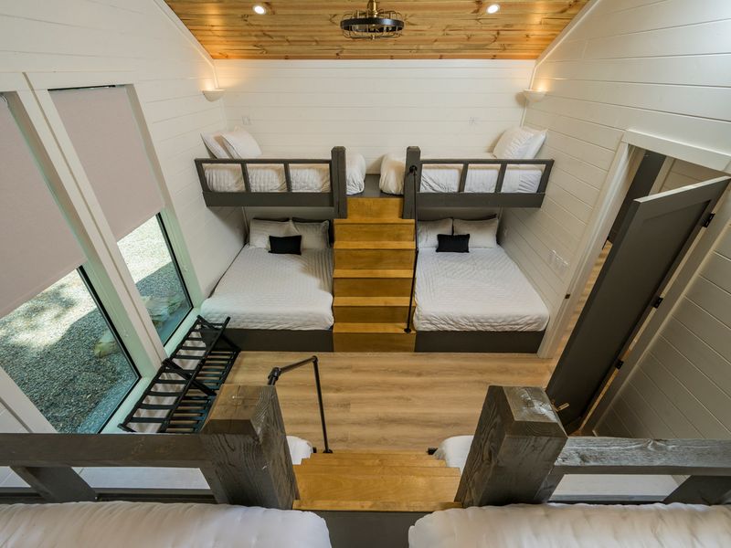 Two comfortable lower beds and two elevated loft beds create a fun, spacious sleeping area for families and groups.