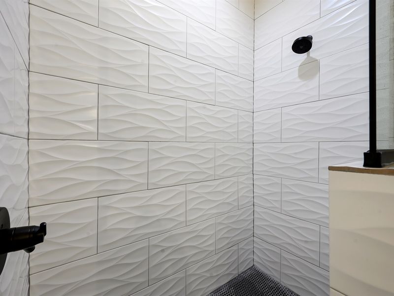 "Relax in the tile shower and double sinks of the primary bathroom."