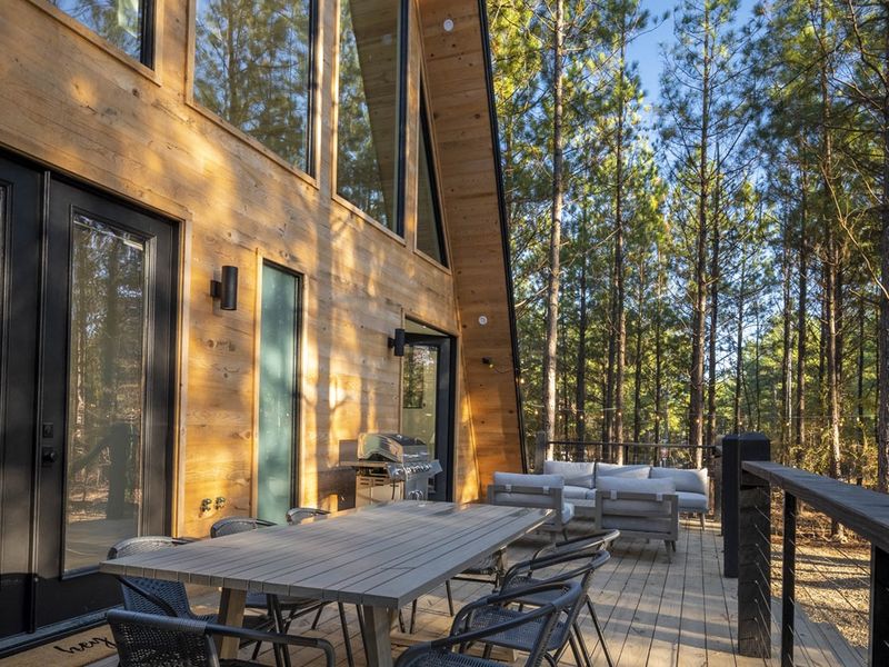The back deck area has a grill, dining for 8, and a lounge area