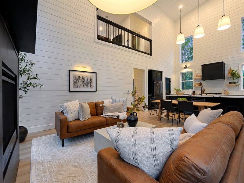 The airy loft above overlooks the main living space, adding to the home’s spacious feel.