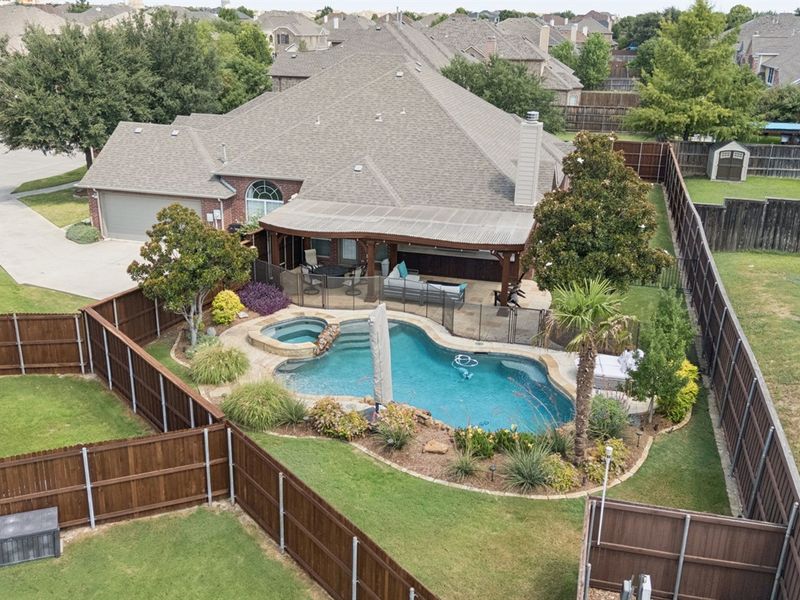 Aerial view showcasing the secluded pool, spa, and spacious backyard retreat.
