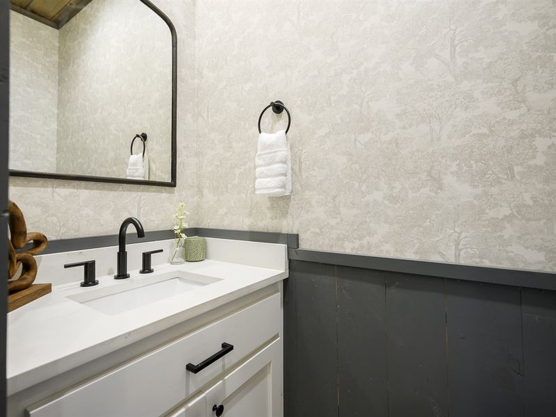 Gorgeous wallpaper in guest bath mimics the forest right outside your door