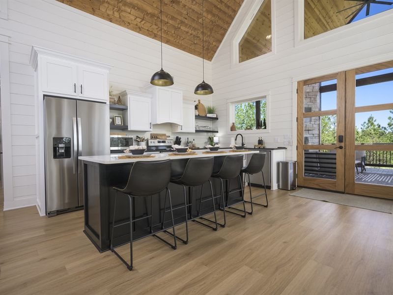 A chef’s paradise with sleek black countertops and stainless steel appliances.