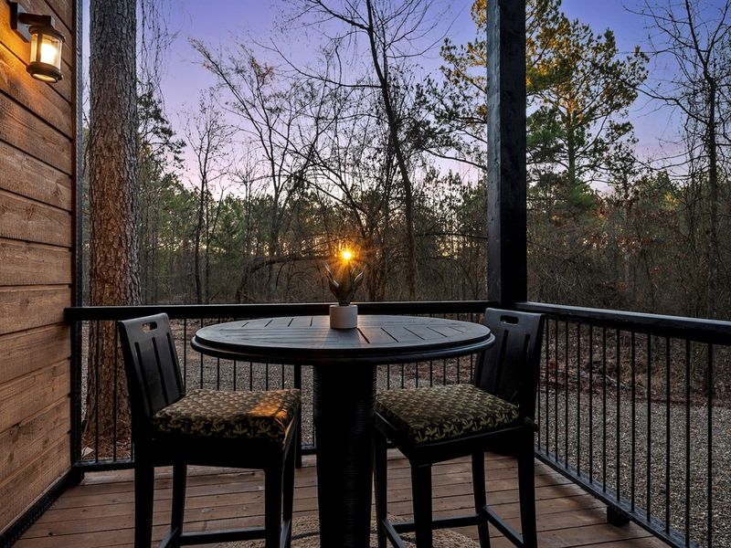 A cozy table for two makes it perfect for morning coffee or evening wine.