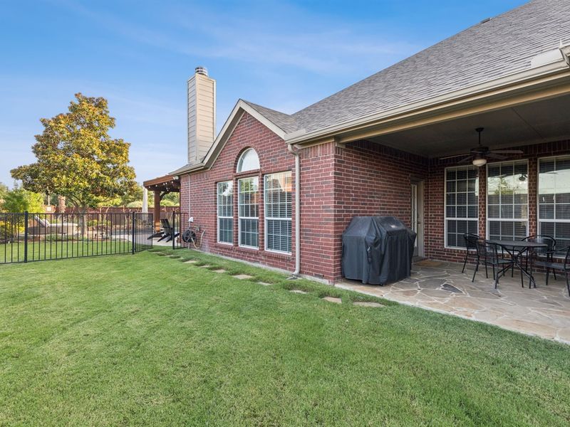 Covered patio with grill and grassy play space for your kids or furbabies.
