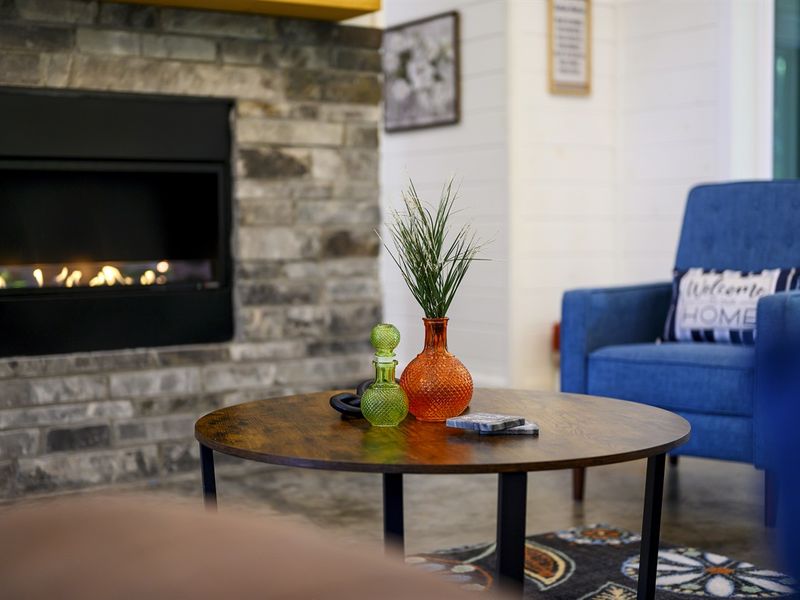 "Cozy up by the gas fireplace and unwind in our plush seating."