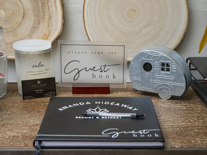 Guest book at Amanda Hideaway Resort & Retreat featuring a sign inviting guests to sign
