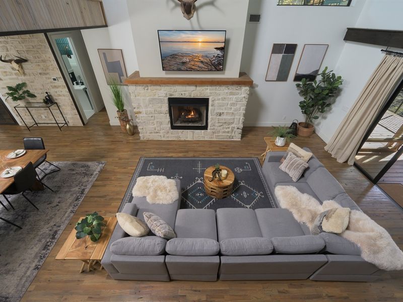 Where everyone comes together — open living anchored by a statement fireplace and warm, inviting textures
