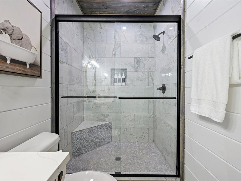 Indulge In Luxury: The ensuite features a spa-like walk-in shower, ideal for relaxing after a busy day exploring
