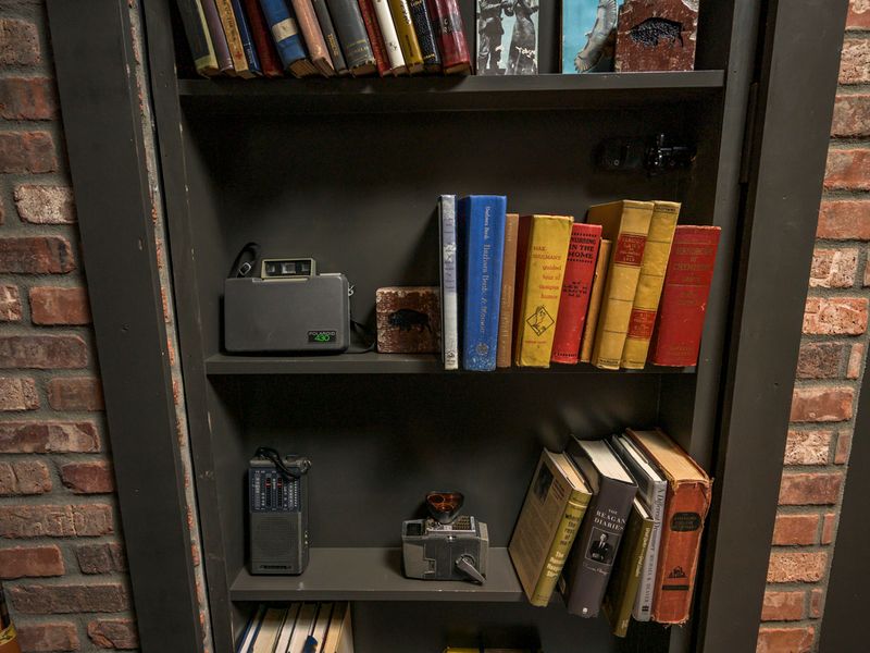 From the antique cameras and binoculars to the vintage books and memorabilia, every detail adds to the speakeasy's old-school charm.