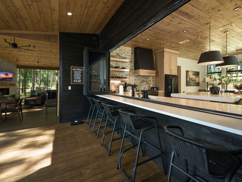 Modern farmhouse-style kitchen with a spacious island, premium appliances, and a seamless flow