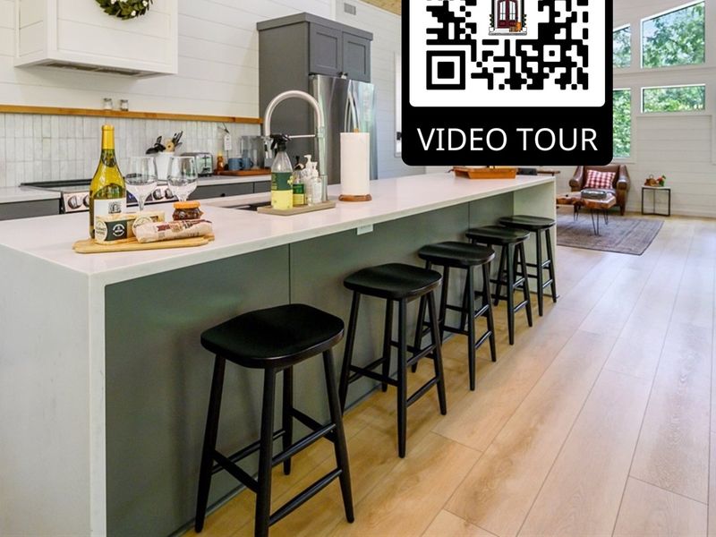 "Transform meal prep into a stylish affair in this kitchen featuring a rustic wood ceiling that adds warmth to the modern bar stools."