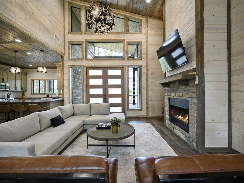 Cozy up by the crackling fireplace in this rustic living room inside a charming cabin nestled in the woods 🍂
