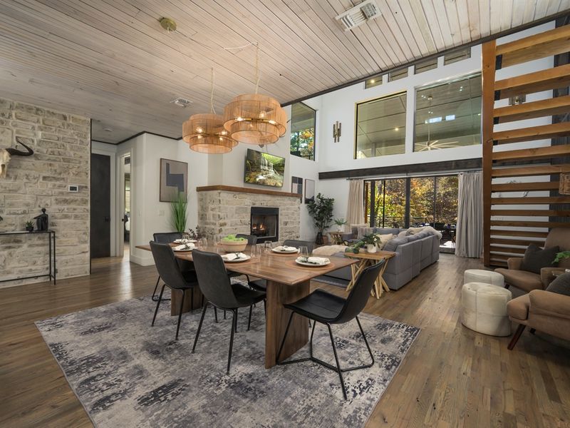 Modern cabin elegance: layered textures, warm wood tones, and a stone fireplace create a beautifully balanced interior