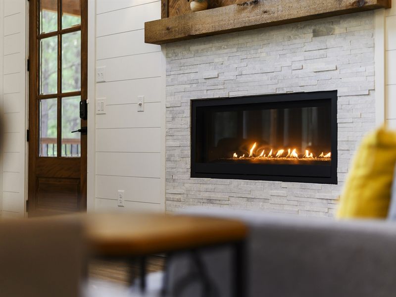 The designer living room has space for everyone to gather around the fireplace
