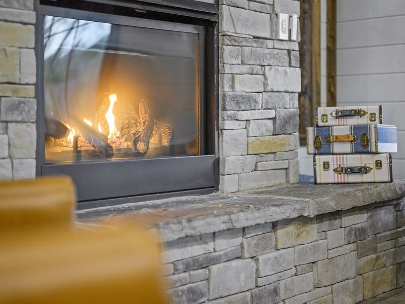 Snuggle up by the cozy fireplace (seasonal)  and let its warm glow create the perfect ambiance for your woodland escape.