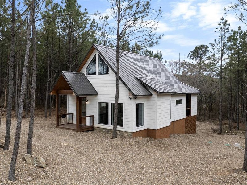 Step into serenity  where towering pines and rustic charm await just minutes from Hochatown