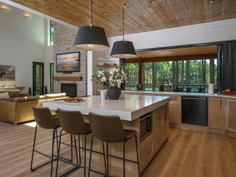Modern farmhouse-style kitchen at Bear Lake Lodge, featuring a spacious island, wooden cabinetry, and large