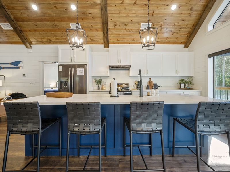 "Gather with loved ones around the oversized island with seating for four in our kitchen."